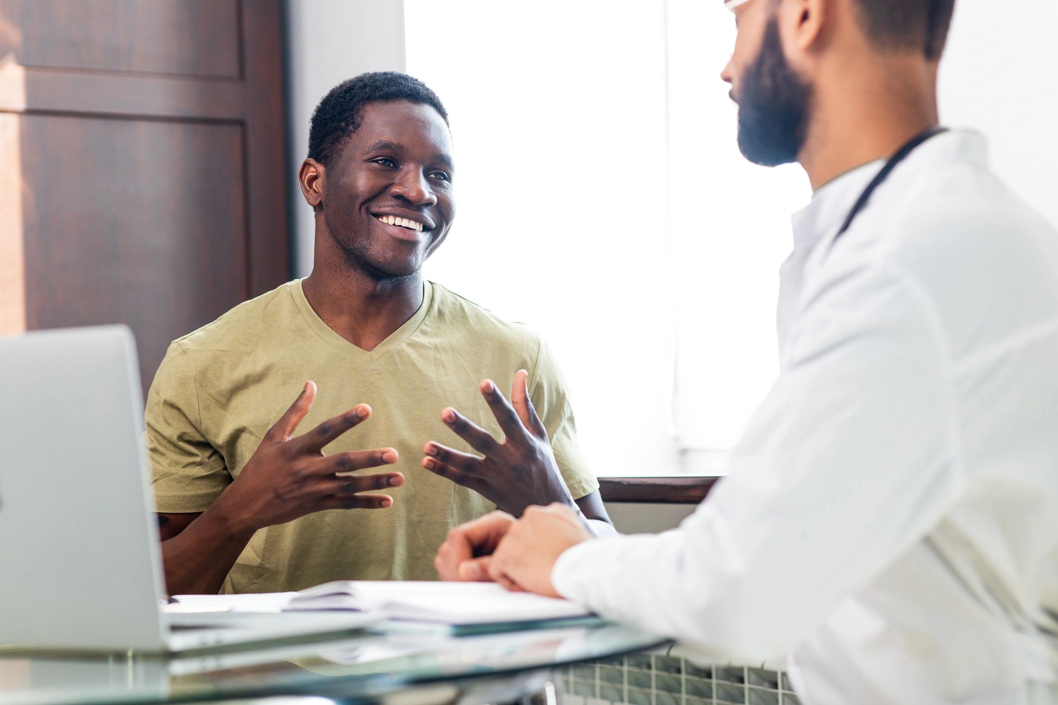 Doctor holding patient hand in supportive gesture