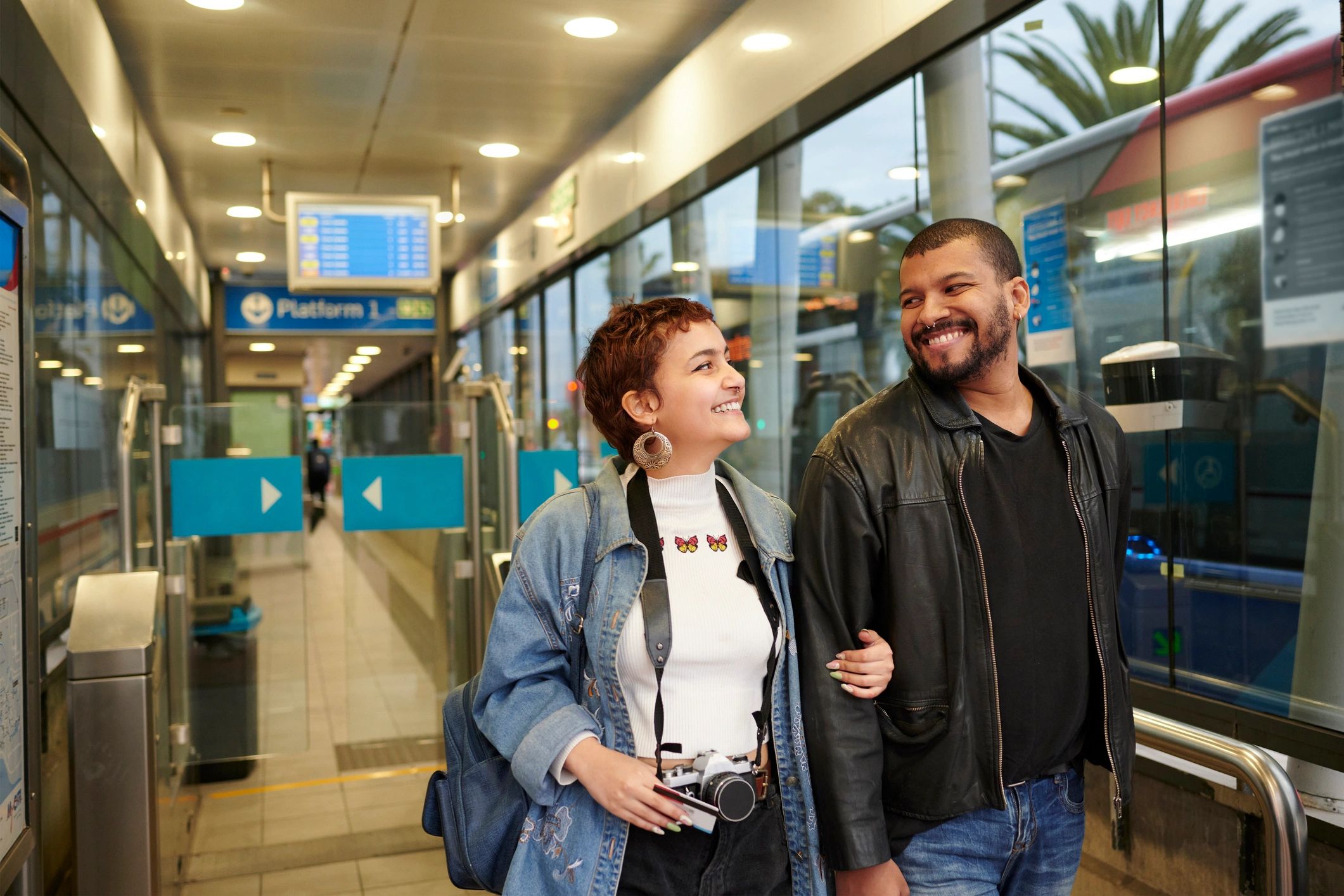 Traveler smiling while walking through a transit terminal