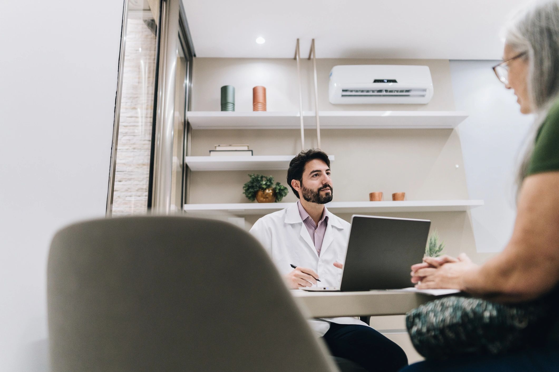 Clinician consulting with a patient in an office