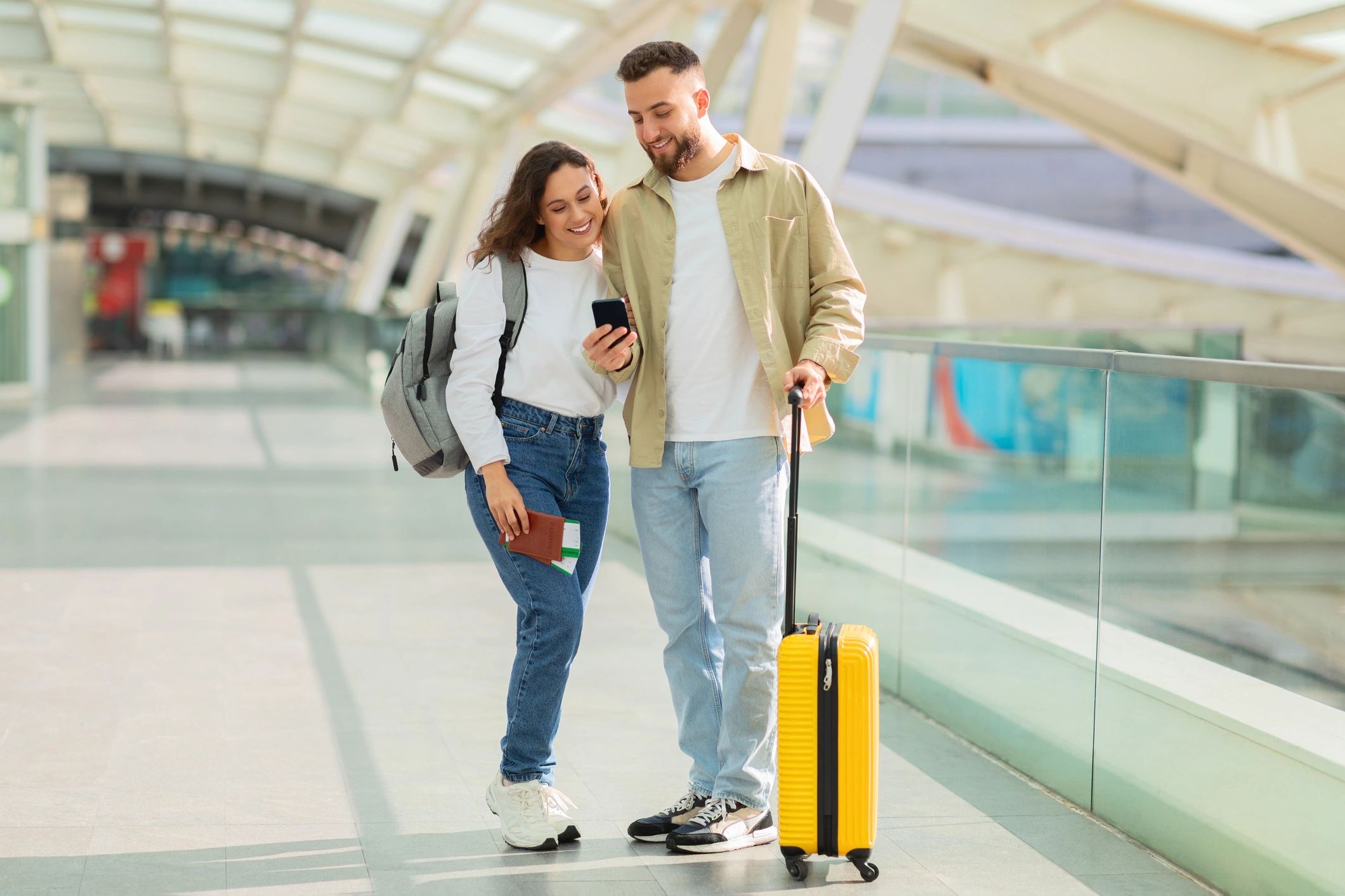 Happy couple walking through a transportation hub