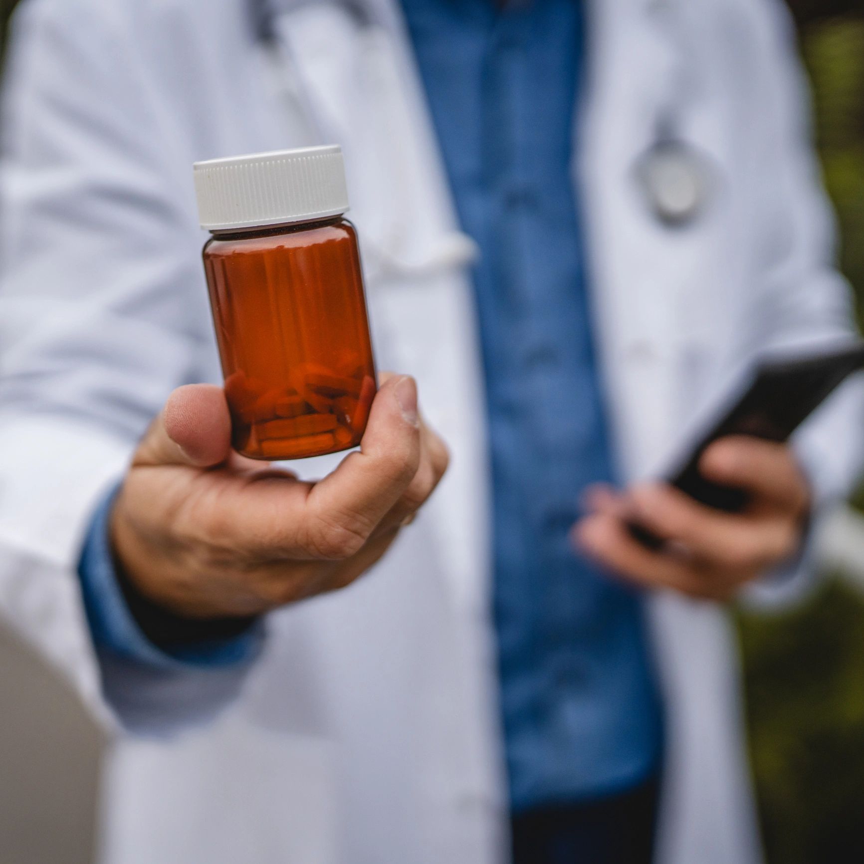 Doctor holding a vaccine vial in a clinical setting